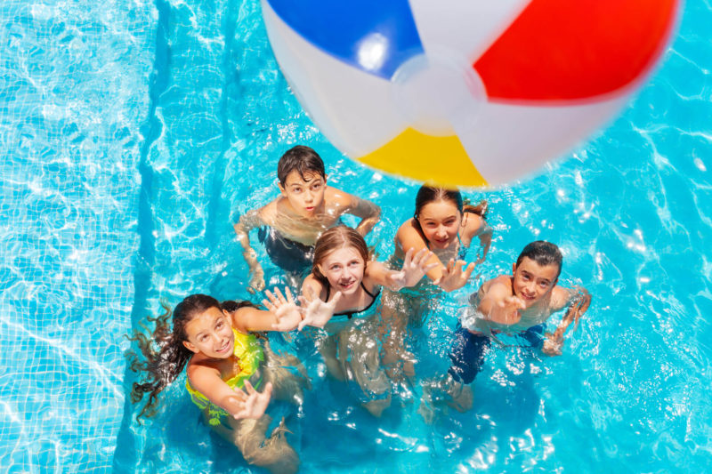 Kids Playing With A Beach Ball In A Dallas Pool